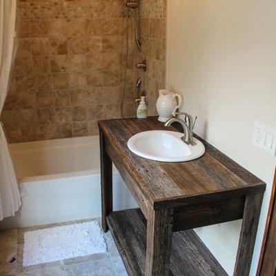 Mid-sized mountain style beige tile ceramic tile bathroom photo in Charlotte with a drop-in sink, open cabinets, wood countertops, beige walls and dark wood cabinets