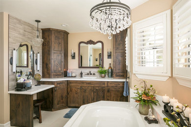 This is an example of a medium sized rustic ensuite bathroom in San Diego with recessed-panel cabinets, a built-in bath, an alcove shower, grey tiles, beige walls, ceramic flooring, a submerged sink, engineered stone worktops, dark wood cabinets, porcelain tiles, white floors and a hinged door.