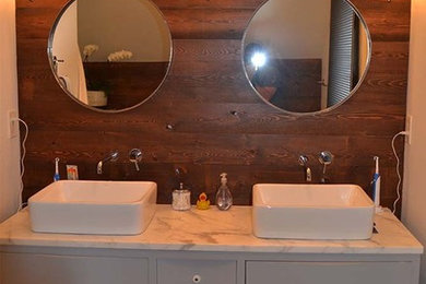 Mid-sized mountain style master white tile and porcelain tile porcelain tile bathroom photo in Orange County with flat-panel cabinets, white cabinets, white walls, a vessel sink and marble countertops