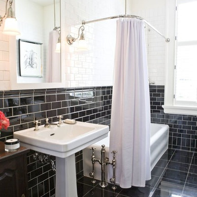 Inspiration for a timeless black tile and subway tile black floor tub/shower combo remodel in Calgary with a pedestal sink, furniture-like cabinets and dark wood cabinets