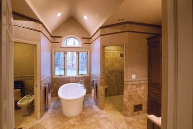 Photo of a classic ensuite bathroom in New York with raised-panel cabinets, dark wood cabinets, a freestanding bath, a corner shower, a one-piece toilet, beige tiles, stone tiles, beige walls, ceramic flooring, a built-in sink and laminate worktops.