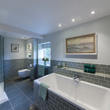 Sage green family bathroom with metro tiles and slate floor