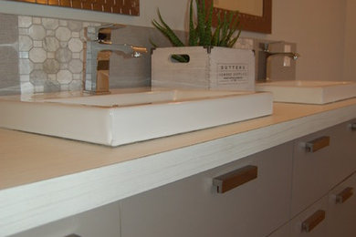 Large minimalist white tile bathroom photo in Montreal with flat-panel cabinets, gray cabinets and laminate countertops