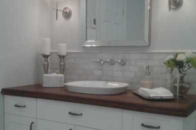 Aménagement d'une petite salle de bain classique avec une baignoire indépendante, une douche d'angle, WC à poser, un carrelage noir et blanc, du carrelage en marbre, un mur gris, un sol en carrelage de céramique, un lavabo intégré et un plan de toilette en bois.