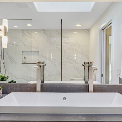 Mid-sized minimalist master white tile and porcelain tile porcelain tile and white floor bathroom photo in Seattle with flat-panel cabinets, white cabinets, a one-piece toilet, white walls, a trough sink, quartz countertops, a hinged shower door and gray countertops