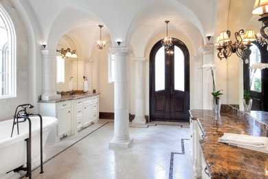 Design ideas for a mediterranean bathroom in Houston with a submerged sink, white cabinets and a freestanding bath.