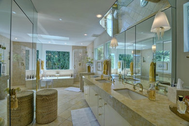 Example of a large trendy master ceramic tile corner shower design in San Francisco with flat-panel cabinets, white cabinets, an undermount tub, an undermount sink, marble countertops and a hinged shower door