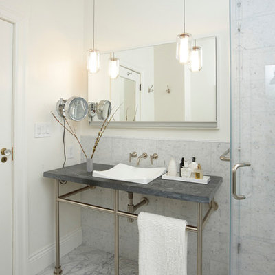 Example of a classic gray tile bathroom design in San Francisco with a console sink and soapstone countertops