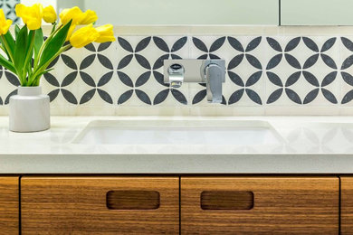 Example of a master bathroom design in San Francisco with flat-panel cabinets and an undermount sink