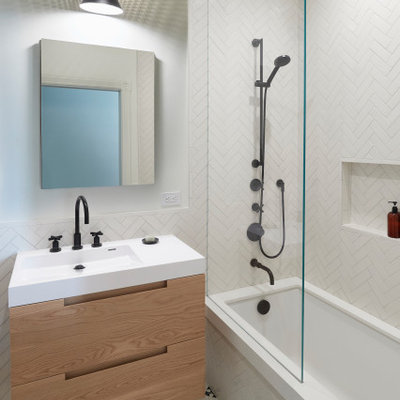 Inspiration for a small 1950s master white tile and ceramic tile cement tile floor, white floor and single-sink bathroom remodel in San Francisco with an undermount tub, a two-piece toilet, flat-panel cabinets, light wood cabinets, white walls, an integrated sink, white countertops, a niche and a floating vanity