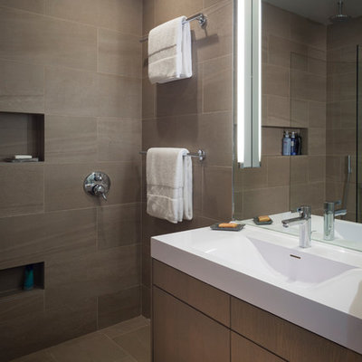 Doorless shower - mid-sized modern master brown tile and porcelain tile porcelain tile doorless shower idea in San Francisco with an integrated sink, flat-panel cabinets, medium tone wood cabinets, quartz countertops and white walls