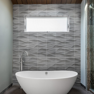 Small trendy gray tile mosaic tile floor freestanding bathtub photo in San Francisco with gray walls