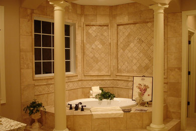 Large elegant beige tile and travertine tile travertine floor and beige floor corner bathtub photo in Other with beige walls