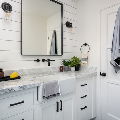 Inspiration for a small cottage 3/4 white tile and porcelain tile porcelain tile and gray floor bathroom remodel in Los Angeles with shaker cabinets, white cabinets, a one-piece toilet, white walls, a trough sink, marble countertops and gray countertops