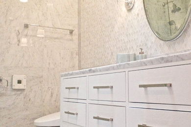 Mid-sized minimalist white tile and stone tile marble floor bathroom photo in San Francisco with an undermount sink, furniture-like cabinets, white cabinets, marble countertops, a one-piece toilet and white walls