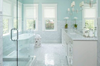 Inspiration for a large transitional master gray tile, white tile and porcelain tile mosaic tile floor and white floor bathroom remodel in Chicago with shaker cabinets, white cabinets, a two-piece toilet, blue walls, an undermount sink, marble countertops and a hinged shower door