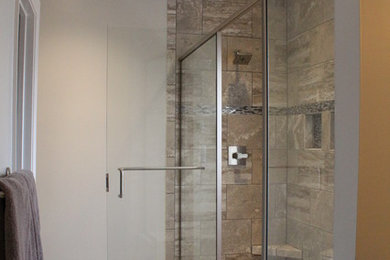 Example of a mid-sized trendy master gray tile and porcelain tile porcelain tile and gray floor double shower design in Nashville with shaker cabinets, dark wood cabinets, blue walls, an undermount sink, quartz countertops and a hinged shower door