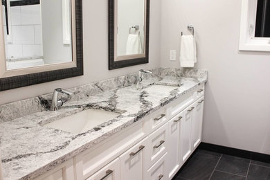 Large elegant master gray tile and porcelain tile porcelain tile bathroom photo in Vancouver with shaker cabinets, white cabinets, gray walls, an undermount sink, quartz countertops and a one-piece toilet