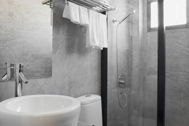 Foto de cuarto de baño moderno de tamaño medio con armarios con paneles lisos, encimera de cemento, paredes grises, suelo de cemento y aseo y ducha