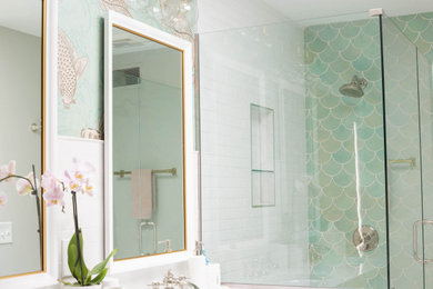 Corner shower - coastal green tile and ceramic tile corner shower idea in Minneapolis with white cabinets, marble countertops, a hinged shower door and white countertops
