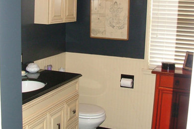 Porcelain tile, black floor, single-sink and wall paneling bathroom photo in Seattle with a one-piece toilet, black walls, a drop-in sink, a hinged shower door, black countertops and a built-in vanity