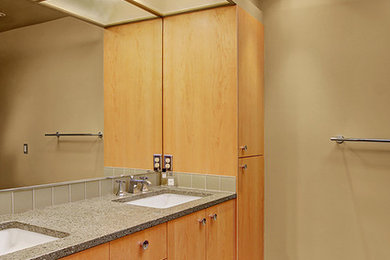 Example of a mid-sized 1960s master green tile and glass tile porcelain tile bathroom design in Seattle with flat-panel cabinets, light wood cabinets, green walls, an undermount sink and recycled glass countertops