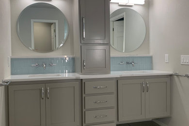 Large traditional ensuite bathroom in Oklahoma City with shaker cabinets, grey cabinets, a built-in shower, blue tiles, grey walls, a submerged sink, engineered stone worktops, a hinged door, white worktops, a shower bench, double sinks and a built in vanity unit.