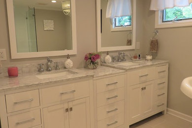 Inspiration for a mid-sized transitional master porcelain tile and gray floor bathroom remodel in New York with shaker cabinets, white cabinets, a two-piece toilet, gray walls, an undermount sink, quartz countertops and a hinged shower door