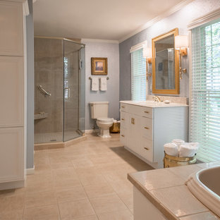 Inspiration for a large timeless master ceramic tile corner shower remodel in Cedar Rapids with blue walls, recessed-panel cabinets, white cabinets, an undermount sink and quartz countertops