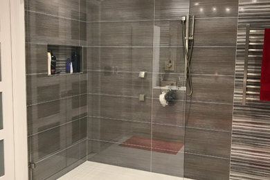 Inspiration for a large modern ensuite bathroom in New York with a freestanding bath, a built-in shower, porcelain tiles, porcelain flooring and an open shower.