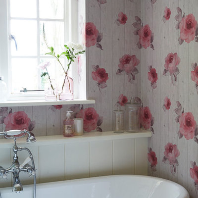 Example of a small cottage chic master claw-foot bathtub design in Sussex with multicolored walls