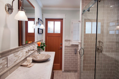 Example of a small arts and crafts 3/4 gray tile and ceramic tile porcelain tile and gray floor bathroom design in San Francisco with shaker cabinets, medium tone wood cabinets, a bidet, green walls, a vessel sink and quartz countertops