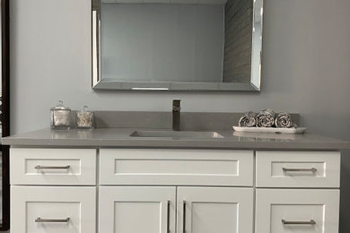 Inspiration for a mid-sized contemporary vinyl floor and gray floor bathroom remodel in Miami with shaker cabinets, white cabinets, gray walls, an undermount sink, quartz countertops and gray countertops