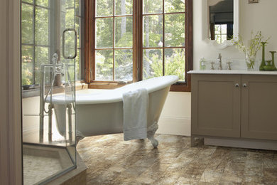 Photo of a large traditional ensuite bathroom in Columbus with shaker cabinets, beige cabinets, a claw-foot bath, a corner shower, beige walls, medium hardwood flooring, a submerged sink and marble worktops.