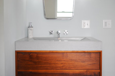 Mid-sized 1950s master ceramic tile bathroom photo in Columbus with furniture-like cabinets, dark wood cabinets, an integrated sink, concrete countertops and gray countertops