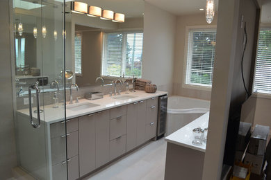 Bathroom - large modern master beige tile and porcelain tile porcelain tile and white floor bathroom idea in Vancouver with flat-panel cabinets, a one-piece toilet, gray cabinets, gray walls, an undermount sink, quartz countertops and a hinged shower door