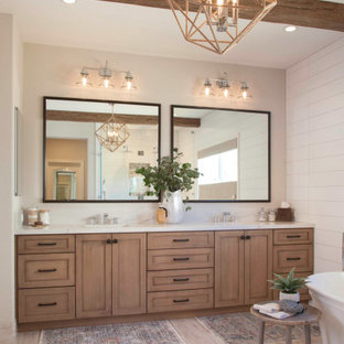 Inspiration for a large cottage master white tile and ceramic tile porcelain tile and beige floor bathroom remodel in San Diego with recessed-panel cabinets, distressed cabinets, a two-piece toilet, white walls, an undermount sink, quartz countertops, a hinged shower door and white countertops