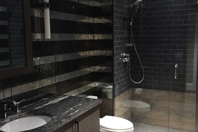 Mid-sized eclectic 3/4 black tile and glass sheet porcelain tile bathroom photo in Denver with flat-panel cabinets, gray cabinets and marble countertops