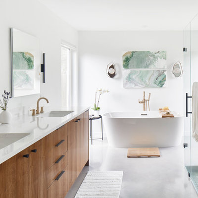 Inspiration for a large contemporary master white tile and ceramic tile white floor and concrete floor bathroom remodel in Austin with flat-panel cabinets, medium tone wood cabinets, white walls, an undermount sink, a hinged shower door, white countertops, a two-piece toilet and quartz countertops