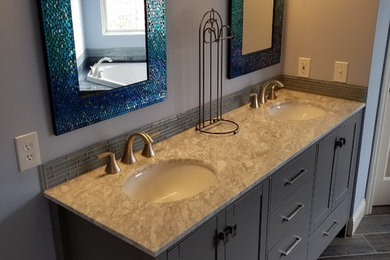 Inspiration for a mid-sized transitional master blue tile and glass tile porcelain tile and gray floor bathroom remodel in Cincinnati with recessed-panel cabinets, gray cabinets, a one-piece toilet, blue walls, an undermount sink and marble countertops