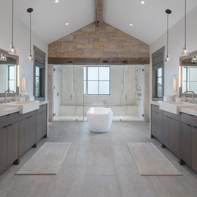 Inspiration for a rustic master beige floor bathroom remodel in Other with flat-panel cabinets, dark wood cabinets, a vessel sink, white walls, quartzite countertops and gray countertops