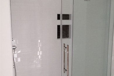 Ejemplo de cuarto de baño actual de tamaño medio con ducha empotrada, baldosas y/o azulejos blancos, baldosas y/o azulejos de cemento y paredes blancas