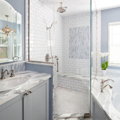 Example of a large beach style master white tile and subway tile marble floor bathroom design in Los Angeles with an undermount sink, gray cabinets, an undermount tub, blue walls, marble countertops and recessed-panel cabinets