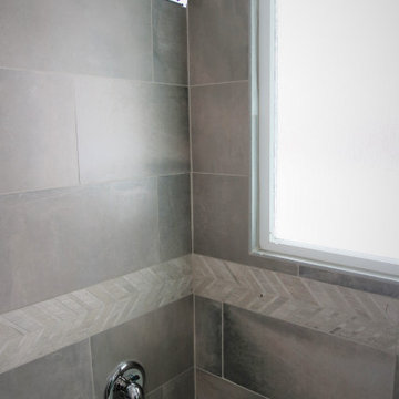 Shower Bath Surround with Natural Stone Tile and Herringbone Mosaic Accent