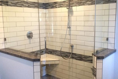 Example of a mid-sized transitional black tile, black and white tile, white tile and matchstick tile corner shower design in San Francisco with white walls and a hinged shower door