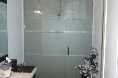 Example of a small urban ceramic tile bathroom design in Toronto with white walls and a hinged shower door