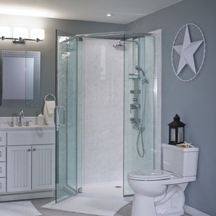 Photo of a mid-sized modern 3/4 bathroom in Other with louvered cabinets, white cabinets, a corner shower, a two-piece toilet, white tile, ceramic tile, grey walls, ceramic floors, an undermount sink and laminate benchtops.