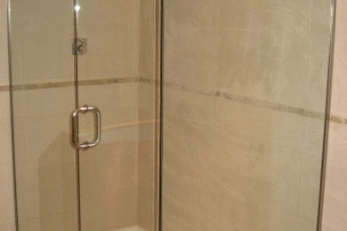 Example of a beige tile and ceramic tile alcove shower design in Vancouver with marble countertops