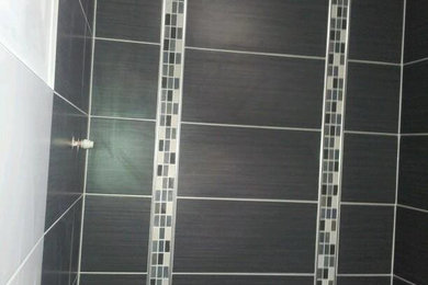 Photo of a contemporary bathroom in Other with black and white tiles.