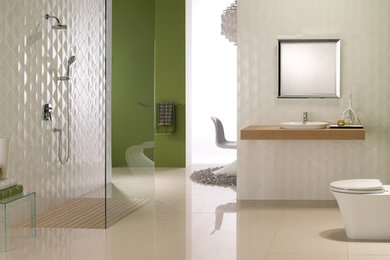 Example of a large trendy 3/4 white tile porcelain tile and beige floor bathroom design in San Luis Obispo with a two-piece toilet, green walls, a vessel sink and wood countertops